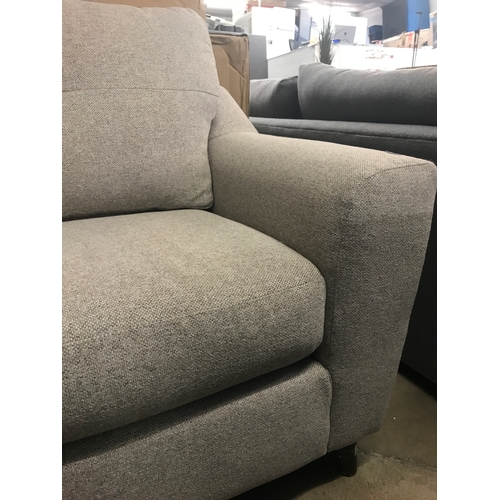 1437 - An oatmeal upholstered three seater sofa