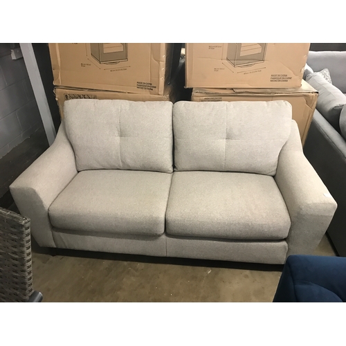 1378 - An oatmeal upholstered three seater sofa