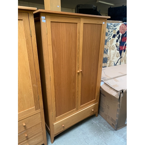 1502 - A lady's oak two door wardrobe with single drawer to the base (H=190 x W=110 x D=62cm)