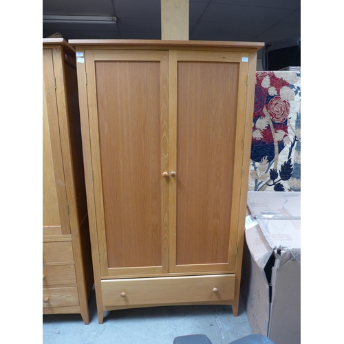 1502 - A lady's oak two door wardrobe with single drawer to the base (H=190 x W=110 x D=62cm)