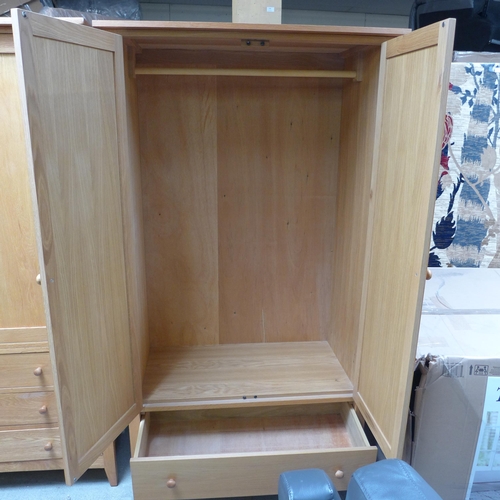 1502 - A lady's oak two door wardrobe with single drawer to the base (H=190 x W=110 x D=62cm)