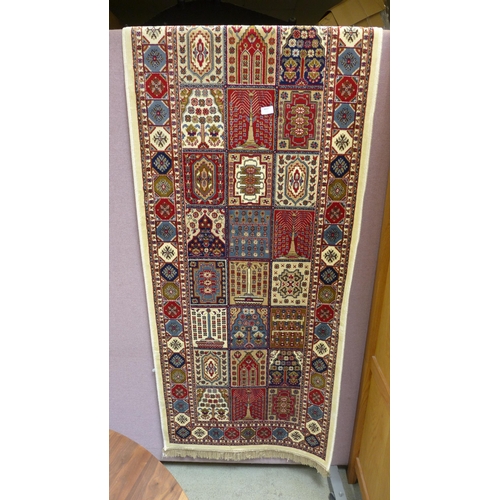 1504 - An ivory ground Cashmere runner, with Persian panel design, 300 x 80cm