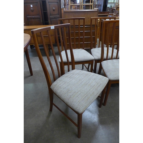 77 - A McIntosh teak extending dining table and eight chairs