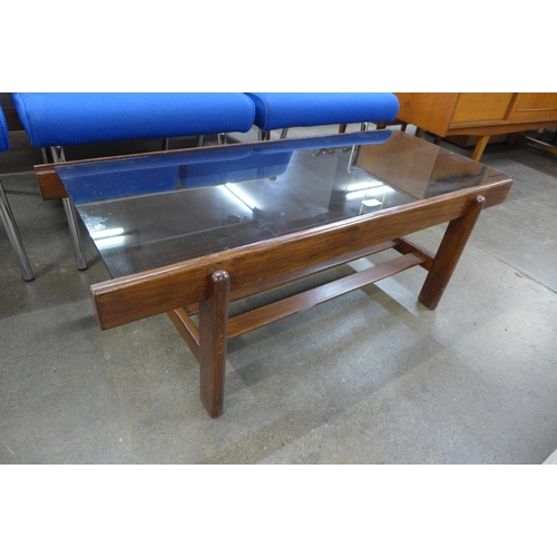 25 - A teak and glass topped rectangular coffee table