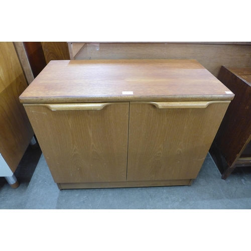 27 - A small Stonehill teak two door cupboard