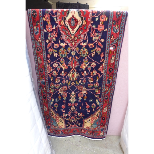 1459 - A rich blue ground Persian Surook runner, multi-coloured field floral design