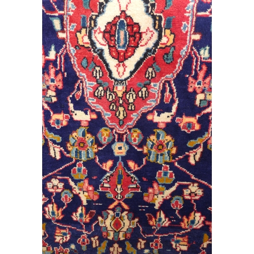 1459 - A rich blue ground Persian Surook runner, multi-coloured field floral design