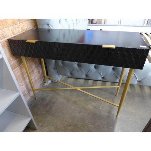 1490 - A black console table with gold legs