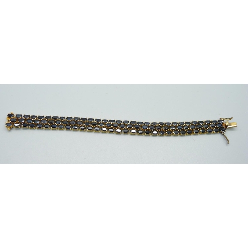 1023 - A silver gilt and onyx bracelet