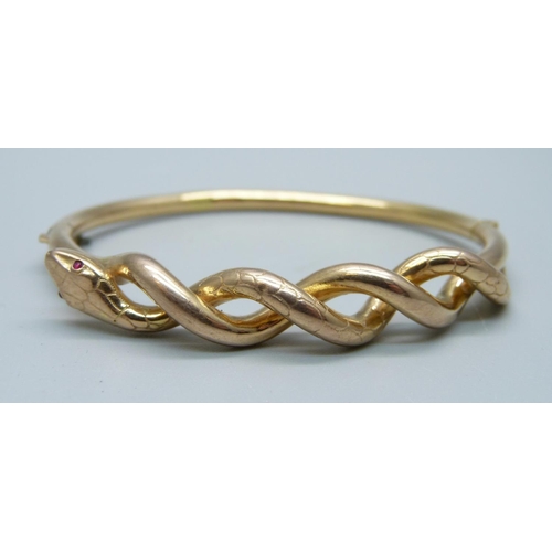 1045 - A yellow metal snake bangle, marked 585, 9.8g