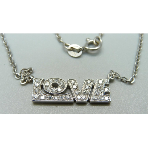 1051 - An 18ct white gold and diamond 'Love' pendant