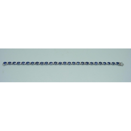 1084 - A white metal, diamond and sapphire tennis bracelet, 8g