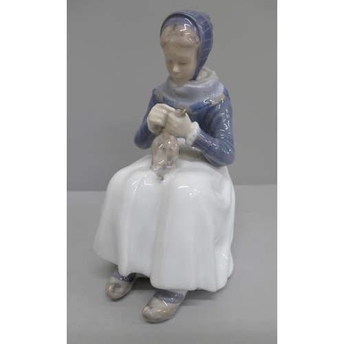 605 - A Royal Copenhagen figure of a girl sewing, 22.5cm