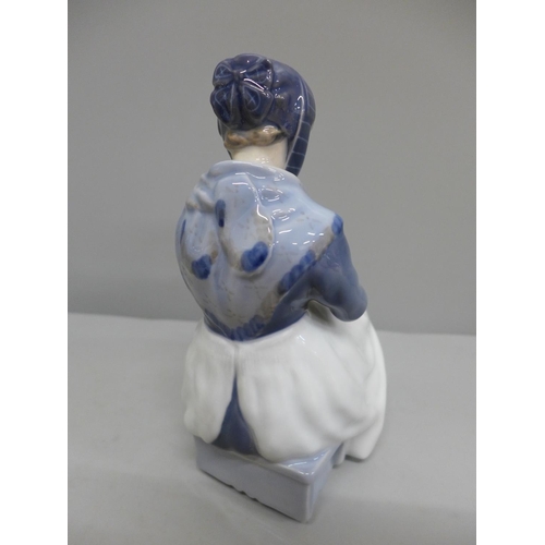 605 - A Royal Copenhagen figure of a girl sewing, 22.5cm