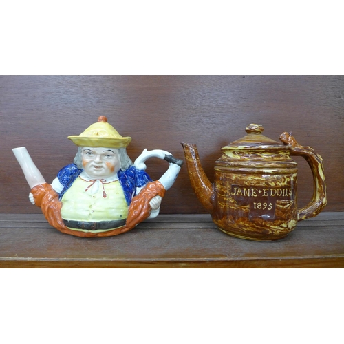 607 - A late 19th Century slipware teapot marked 'Jane Eddils 1895', a/f, and a character teapot