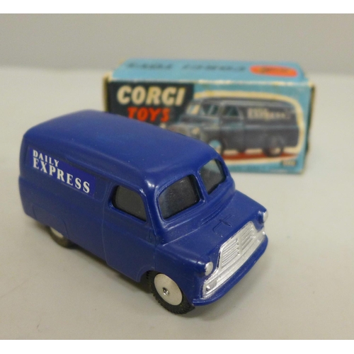 613 - A Corgi Toys no.403 12cwt Delivery Van comprising of dark blue body with flat spun hubs and Daily Ex... 