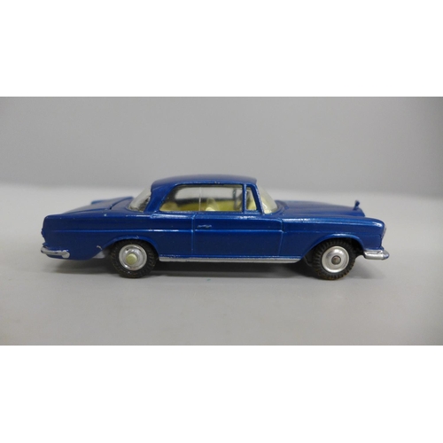 623 - A Corgi no.253 Mercedes 220SE Coupe with blue body and lemon interior, luggage in boot, spare wheel ... 