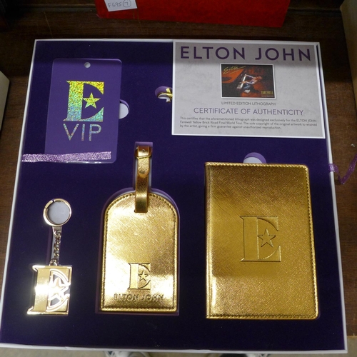 696 - An Elton John tour souvenir box and contents