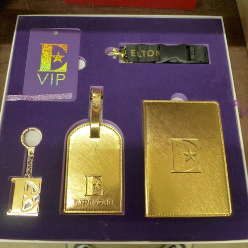 696 - An Elton John tour souvenir box and contents