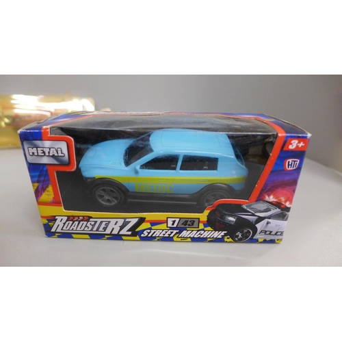 703 - A Matchbox Speedkings 'Barracuda' model car, a Roadsterz Street Machine, Corgi Ford Contina police c... 