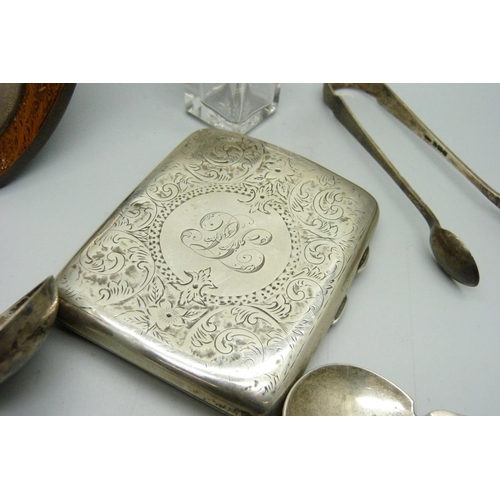 829 - A silver cigarette case, six silver spoons, a pair of silver sugar bows, a silver topped bottle and ... 