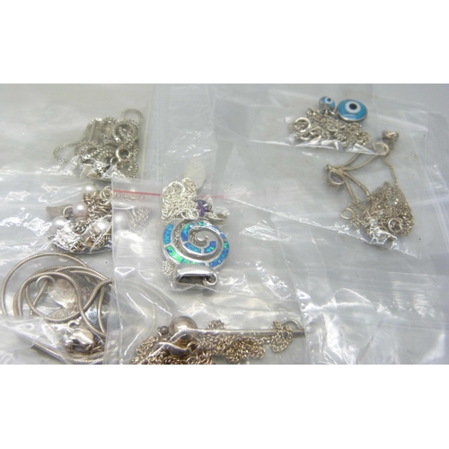 858 - Twenty five silver pendants and chains