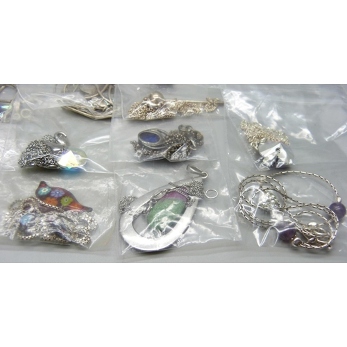 858 - Twenty five silver pendants and chains