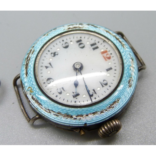 915 - A silver watch in case and with key, and two silver cased wristwatches