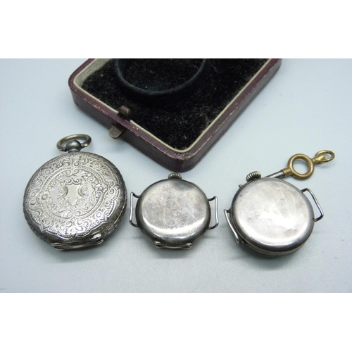 915 - A silver watch in case and with key, and two silver cased wristwatches