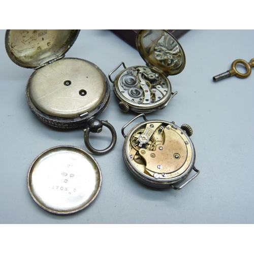 915 - A silver watch in case and with key, and two silver cased wristwatches