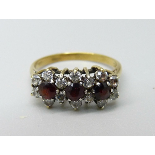 945 - A silver gilt triple cluster ring, L