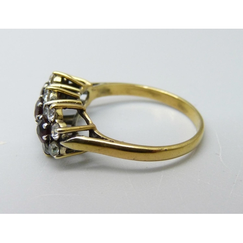 945 - A silver gilt triple cluster ring, L