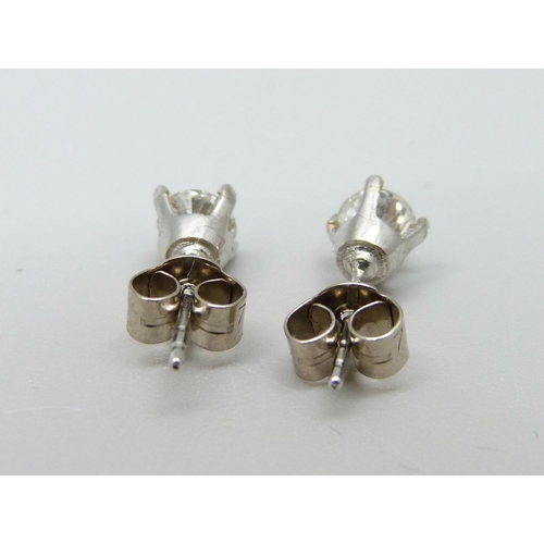 955 - A pair of 18ct white gold and diamond solitaire earrings, approximately 0.50ct total diamond weight