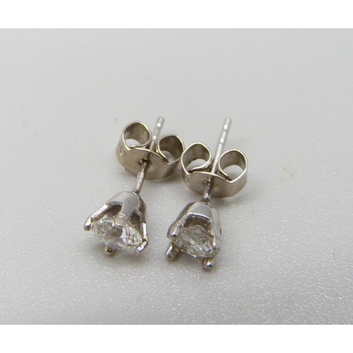 955 - A pair of 18ct white gold and diamond solitaire earrings, approximately 0.50ct total diamond weight