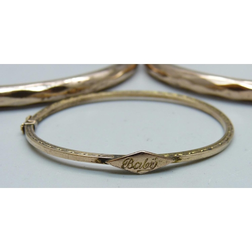 985 - Two rolled gold bangles and a baby's bangle