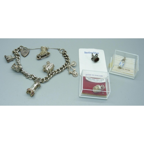 994 - A silver charm bracelet, 51g, and loose charms