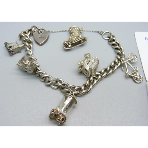 994 - A silver charm bracelet, 51g, and loose charms