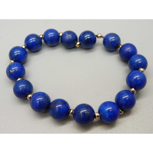 997 - A lapis lazuli bracelet with yellow metal spacers