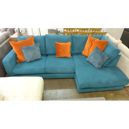 1377 - A turquoise corduroy upholstered L shaped sofa with burnt orange scatter cushions