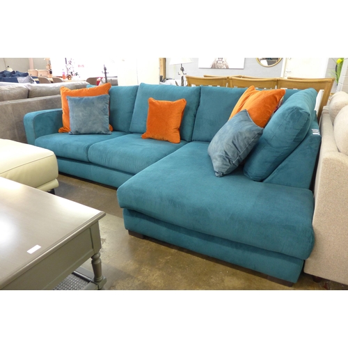 1377 - A turquoise corduroy upholstered L shaped sofa with burnt orange scatter cushions