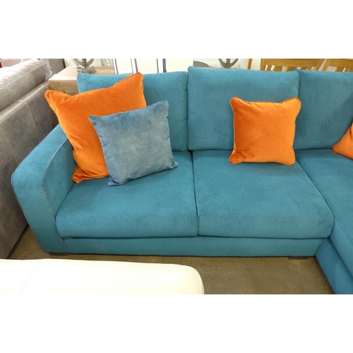 1377 - A turquoise corduroy upholstered L shaped sofa with burnt orange scatter cushions