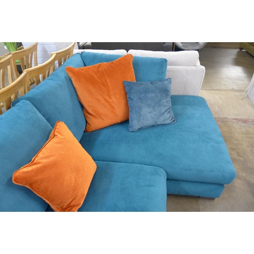 1377 - A turquoise corduroy upholstered L shaped sofa with burnt orange scatter cushions