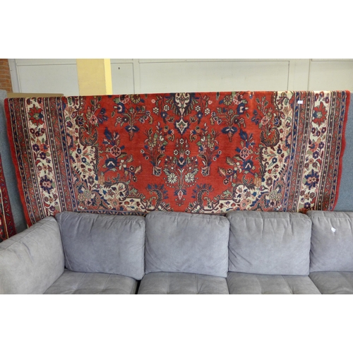 1517 - A washed red ground, full pile, Persian carpet, from Surook region of Iran with traditional floral m... 