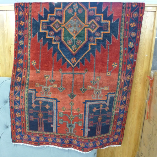 1572 - A rich red and blue ground Persian Hamadan village rug, 254cm x 132cm