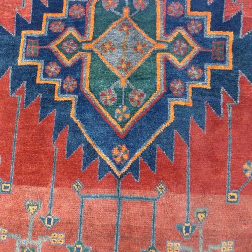 1572 - A rich red and blue ground Persian Hamadan village rug, 254cm x 132cm