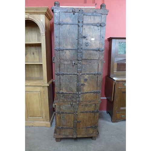 102 - A large 19th Century style Indian hardwood and ironwork three door wedding cupboard