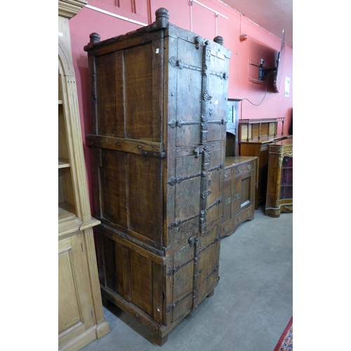 102 - A large 19th Century style Indian hardwood and ironwork three door wedding cupboard