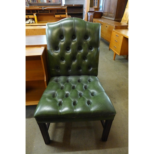 107A - A Regency style mahogany and green leather library chair