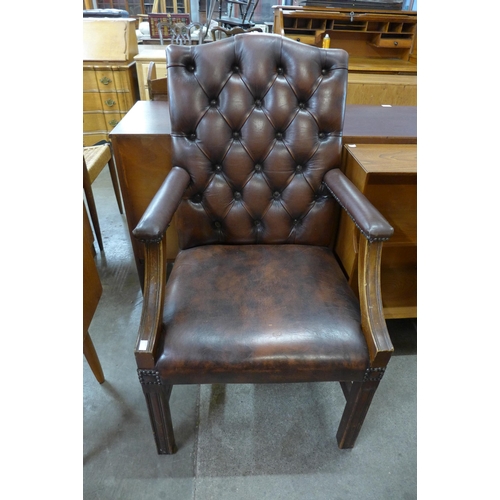 107B - A Regency style mahogany and chestnut brown leather library chair