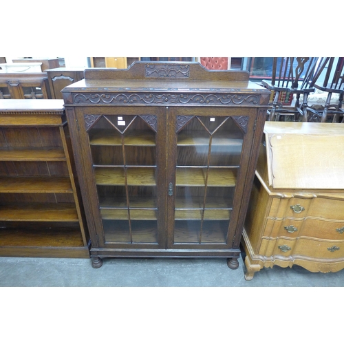 121 - An early 20th Century carved oak two door bookcase